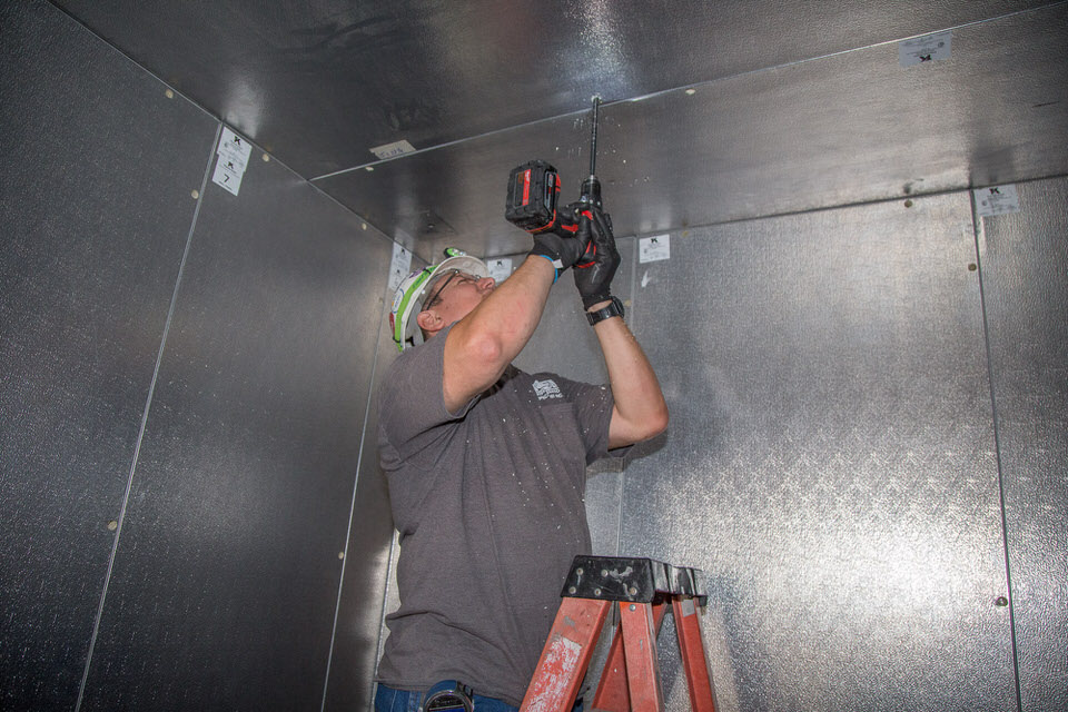 drilling the evaporator holes for the Walk-in Cooler Installation